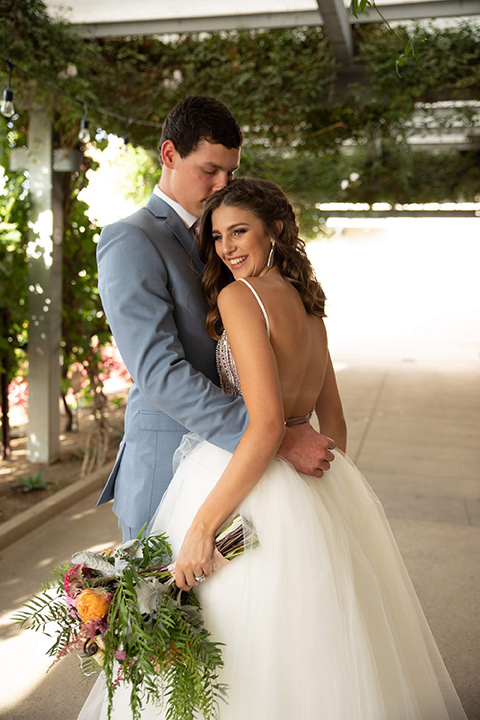 Callaway-Styled-Shoot-bride-and-groom-close-bride-in-a-tulle-ballgown-with-a-colorful-beaded-bodice-groom-in-a-light-blue-suit