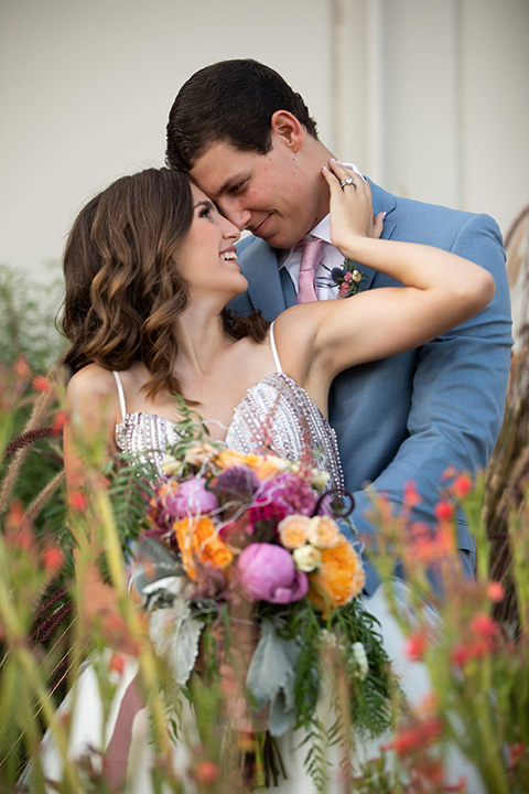 Callaway-Styled-Shoot-bride-and-groom-touching-heads-bride-in-a-tulle-ballgown-with-a-colorful-beaded-bodice-groom-in-a-light-blue-suit