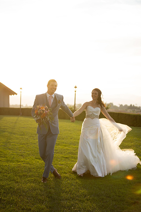 Callaway-Styled-Shoot-bride-and-groom-walking-bride-in-a-tulle-ballgown-with-a-colorful-beaded-bodice-groom-in-a-light-blue-suit