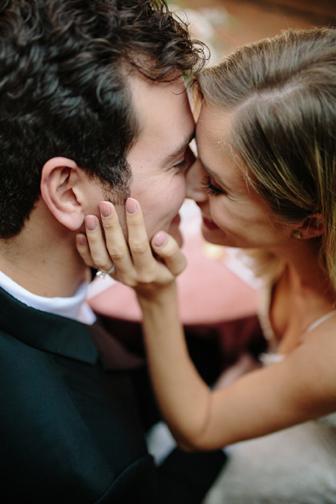 Carondelet-House-wedding-bride-and-groom-overhead-close-up-bride-in-a-lace-gown-with-an-illusion-neckline-and-thin-straps-groom-in-a-traditional-black-tuxedo-with-a-black-bow-tie