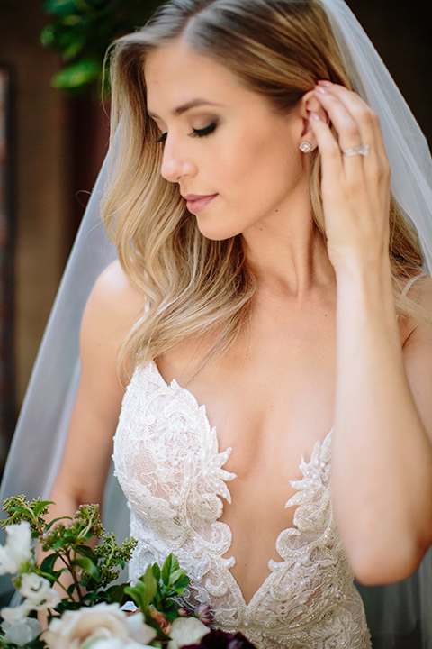 Carondelet-House-wedding-bride-close-up-in-a-lace-gown-with-an-illusion-neckline-and-thin-straps