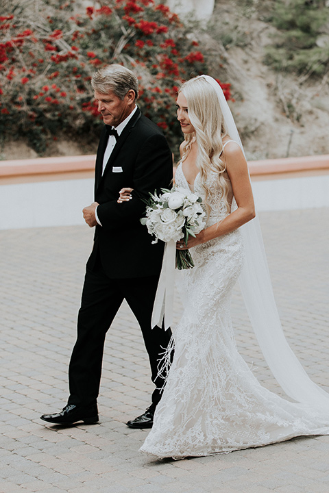 rancho-las-lomas-real-wedding-bride-and-father-thefather-in-a-black-nothc-lapel-tuxedo-the-bride-is-in-a-white-lace-formfitting-gown-with-straps