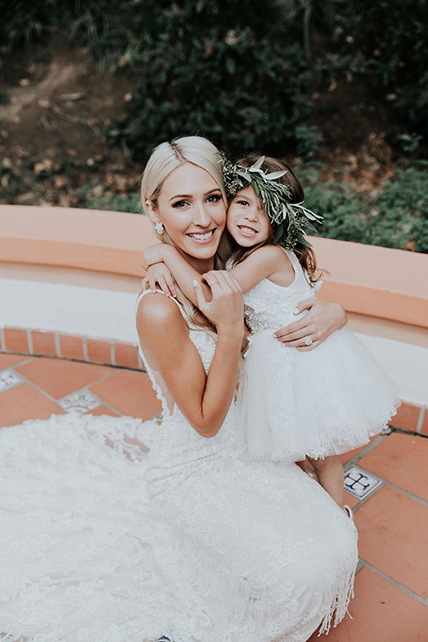 rancho-las-lomas-real-wedding-bride-and-flower-girl-in-a-white-lace-formfitting-gown-with-straps