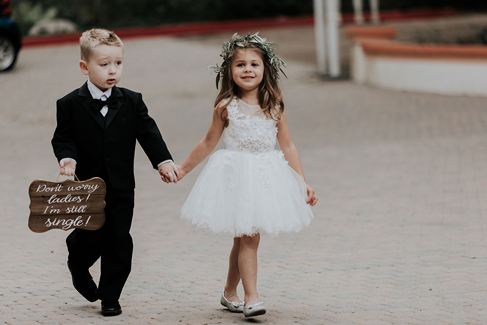 rancho-las-lomas-real-wedding-flower-girl-and-ringbarer-the-ringbarer-wore-a-black-tuxedo-with-black-bow-tie-the-flower-girl-wore-a-white-tulle-dress