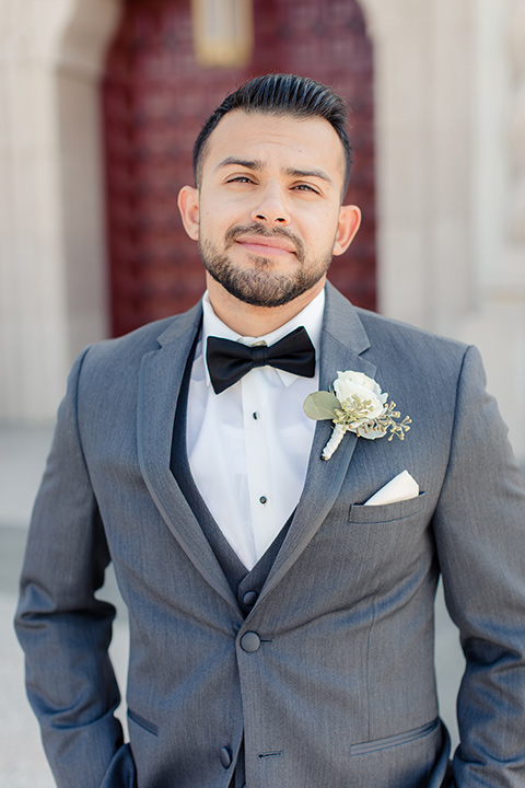 kellogg-house-pomona-wedding-groom-in-a-dark-grey-suit-with-a-black-bow-tie