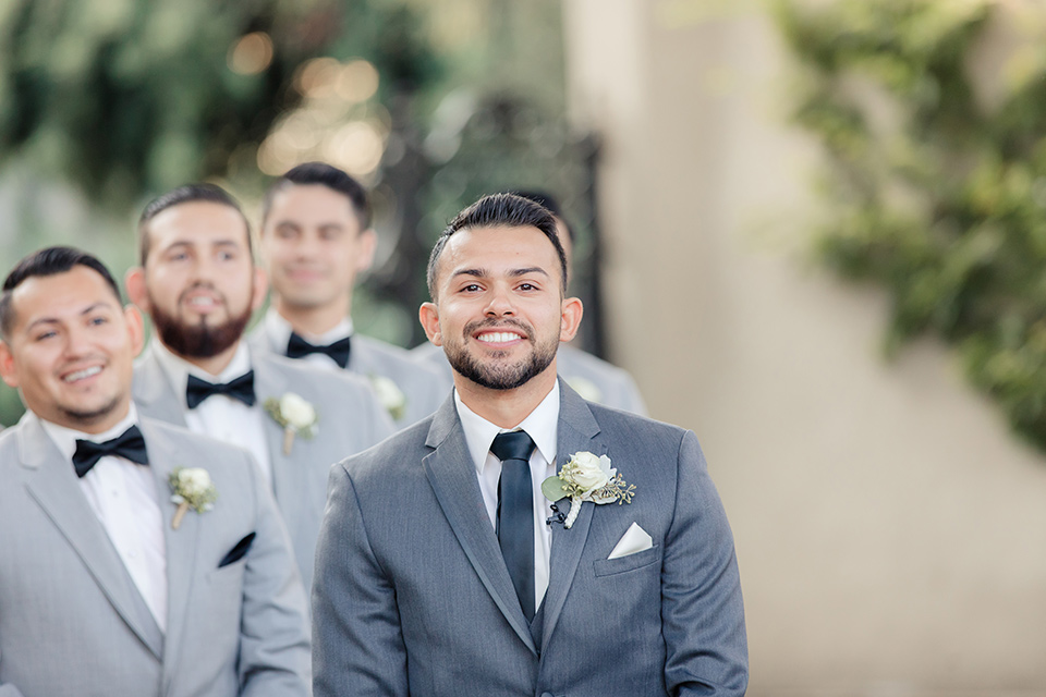 kellogg-house-pomona-wedding-groomsmen-at-ceremony-groomsmen-the-groomsmen-in-light-grey-suits-and-the-groom-in-a-dark-grey-tuxedo