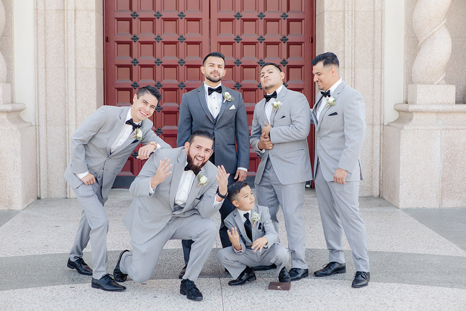 kellogg-house-pomona-wedding-groomsmen-the-groomsmen-in-light-grey-suits-and-the-groom-in-a-dark-grey-tuxedo