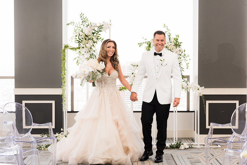 City-club-shoot-bride-and-groom-after-ceremony-bride-in-a-white-ballgown-with-a-sweetheart-neckline-and-straps-groom-in-a-white-coat-with-black-pants