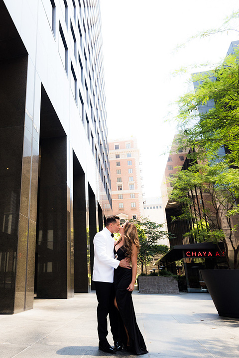 City-club-shoot-bride-and-groom-outside-venue-bride-in-a-white-ballgown-with-straps-and-a-sweetheart-neckling-groom-in-a-white-coat-with-black-pants