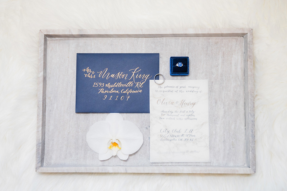 City-club-shoot-invitations-with-white-paper-and-navy-lettering-and-blue-envelopes