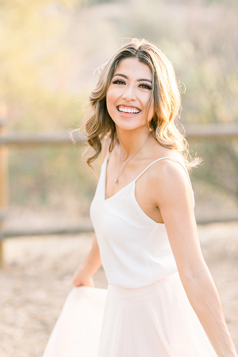 Claudia+Johns-meadow-elopement-bride-close-up-in-a-two-toned-gown-with-a-blush-skirt-and-a-white-silk-top-with-thin-straps