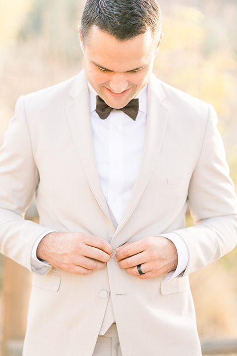 Claudia+Johns-meadow-elopement-groom-fixing-jacket