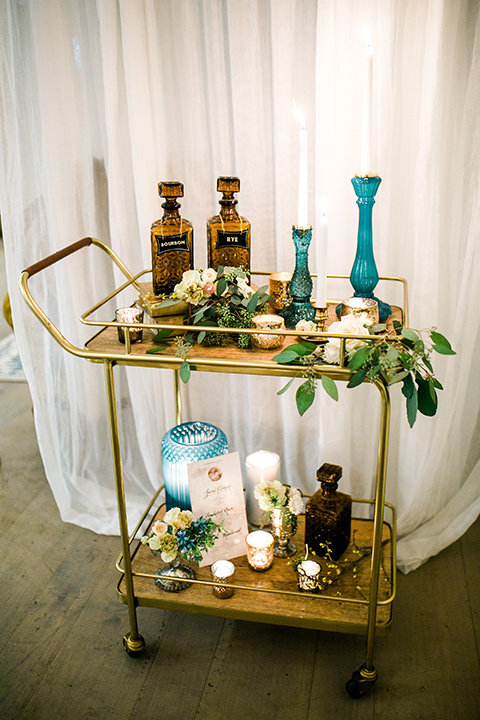 cooks chapel wedding bar cart with florals and candles with light blue stands