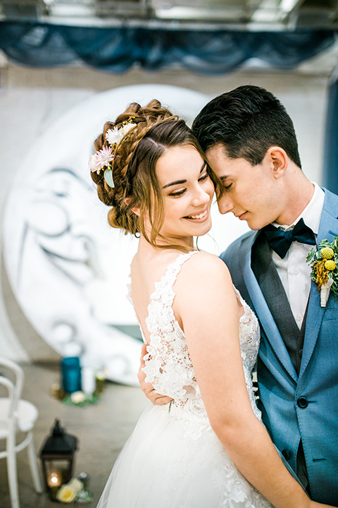 Wedding bride and groom touching heads at the ceremony in front of the wedding arch 