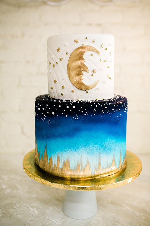  Wedding cake with blue, gold, and white celestial decor 