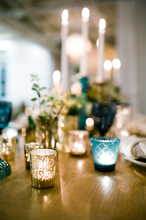 Cooks chapel wedding table decor and candles in gold and blue hues