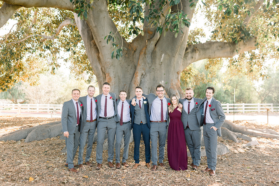 red-barn-wedding-groomsmen-groomsmen-in-grey-suits-groom-in-a-blue-suit