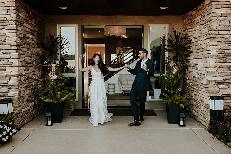 Dragon-point-villa-wedding-bride-and-groom-dancing-bride-in-a-white-ballgown-with-pockets-and-thin-straps-groom-in-a-black-suit-with-a-white-tie