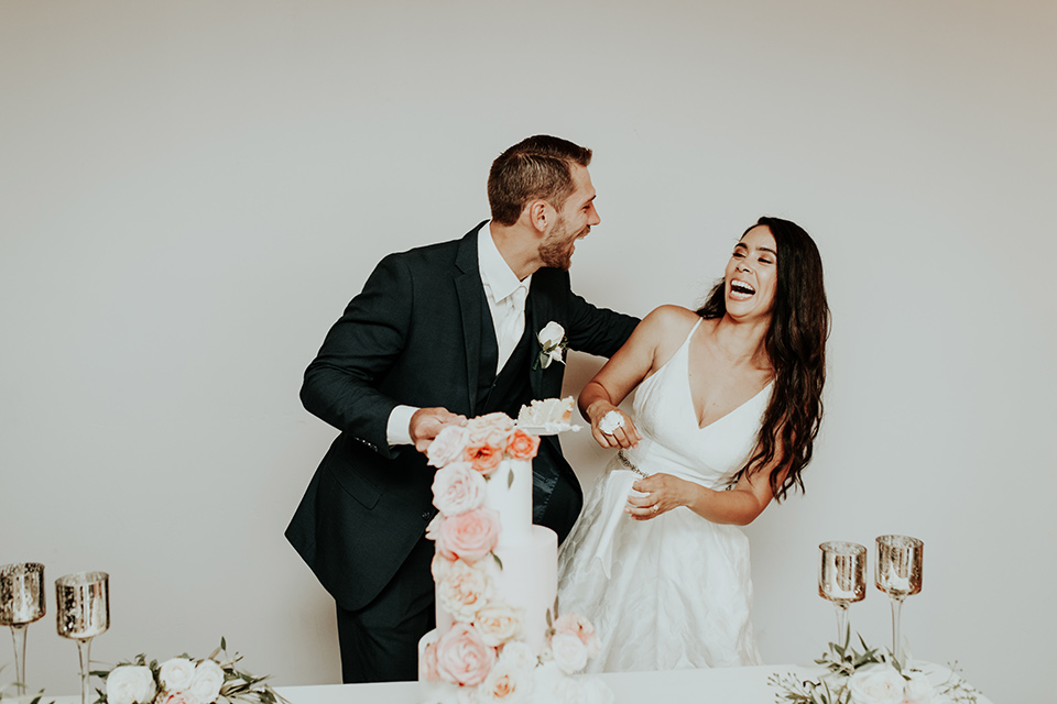 Dragon-point-villa-wedding-bride-and-groom-with-cake-smashed-in-their-faces-cake-bride-in-a-white-ballgown-with-pockets-and-thin-straps-groom-in-a-black-suit-with-a-white-tie