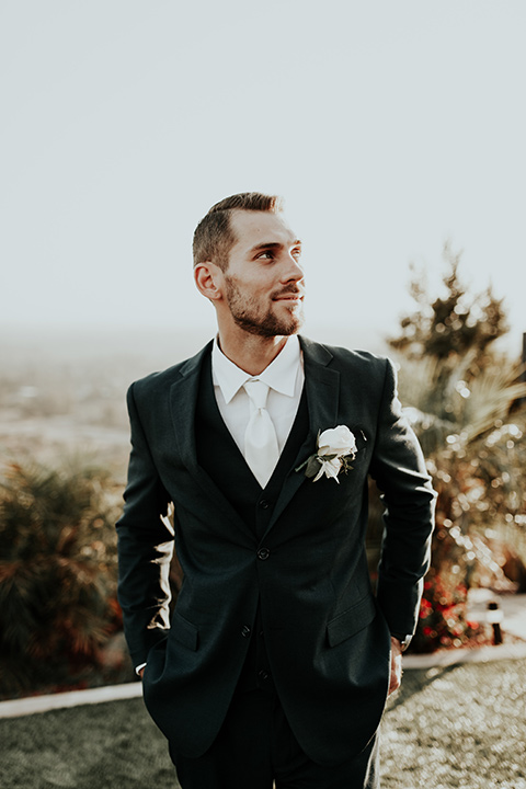 Dragon-point-villa-wedding-groom-close-up-with-a-black-suit-on-with-a-white-tie