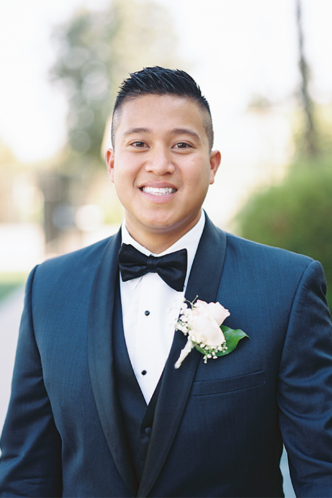 Elements-Venue-presents-wedding-groom-close-up-in-a-navy-shawl-lapel-tuxedo-with-a-black-bow-tie