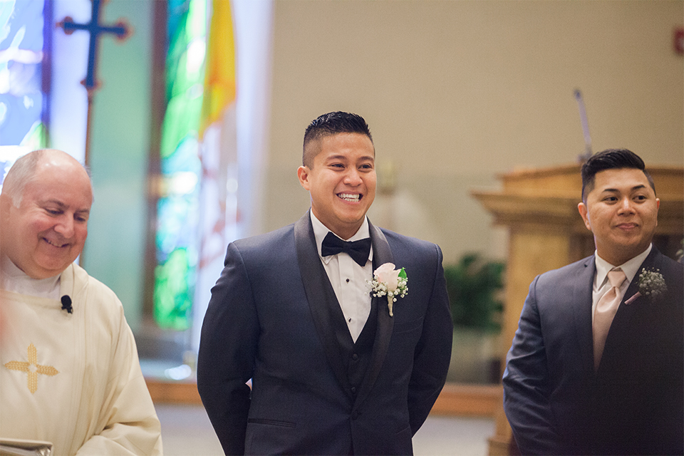 Elements-Venue-presents-wedding-groom-looking-at-his-bride-in-a-navy-blue-shawl-lapel-tuxedo-with-a-black-bow-tie