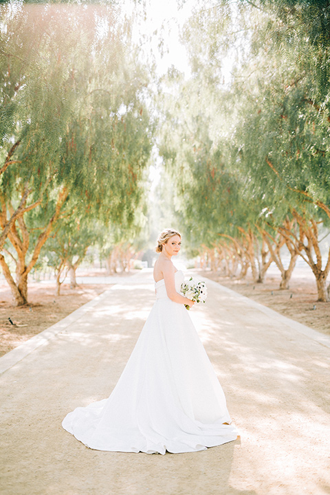 bride in a white strapless ballgown with a bow detail and hair in a bun