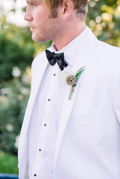  groom in a white jacket and black pants