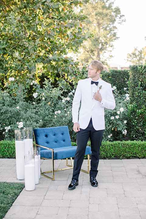  groom in a white jacket and black pants 