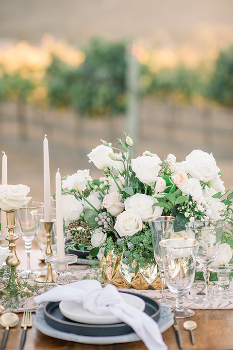  wooden table with white florals and flatware 