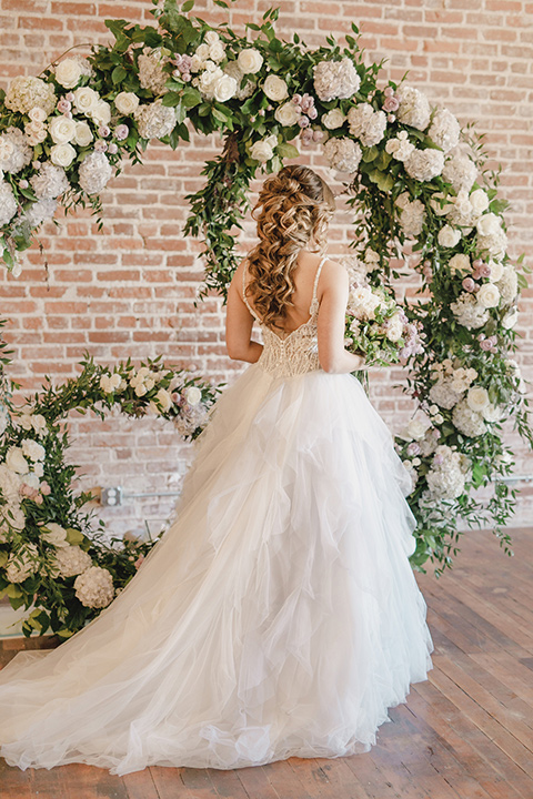 bride in a tulle white gown with a low back detail and a sweetheart neckline