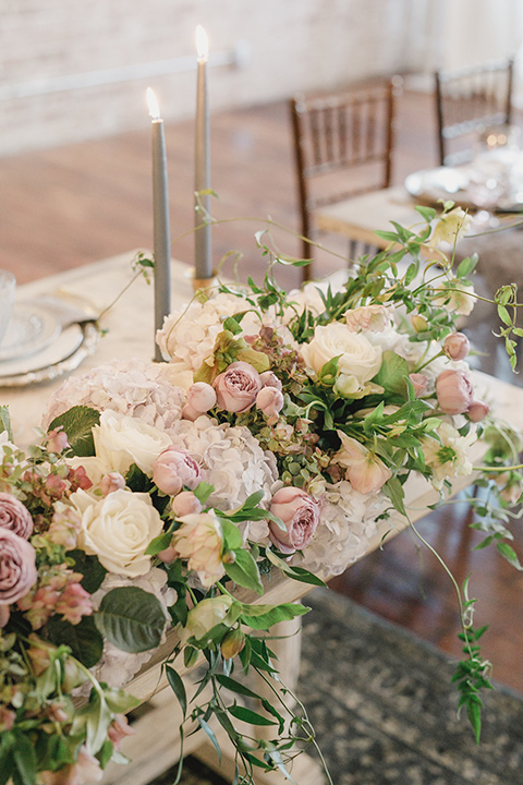 white pink and green florals with tall candles and white chairs