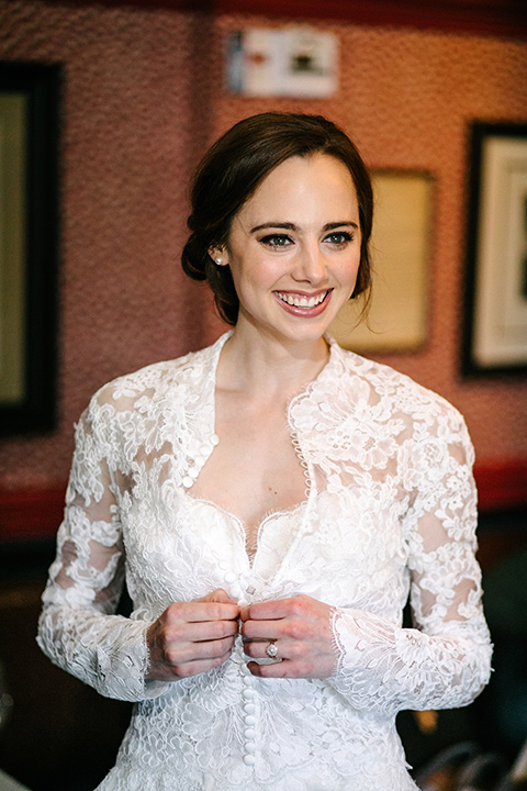 bride in a white flowing gown with long and high neckline sleeves