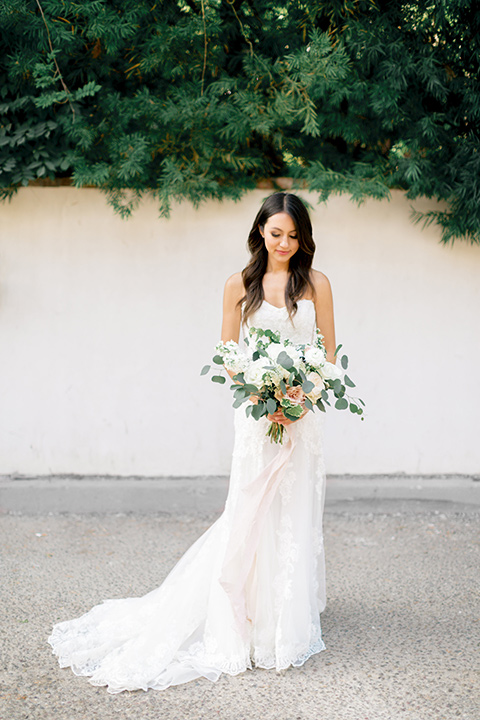 franciscan-gardens-wedding-bride-alone-in-a-mermaid-white-strapless-gown-with-hair-down-in-a-simple-wave