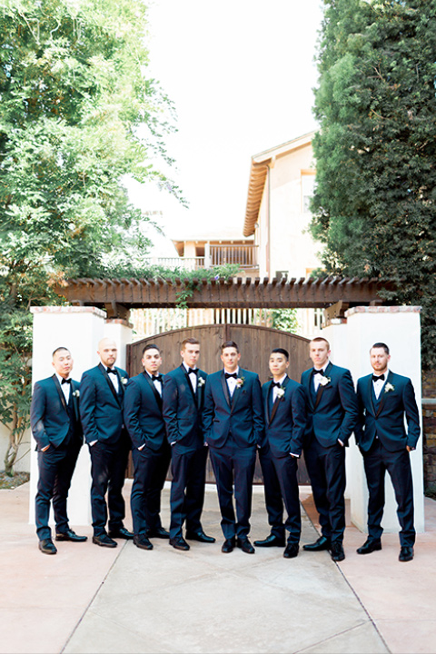 franciscan-gardens-wedding-groomsmen-and-groom-in-a-navy-shawl-lapel-tuxedo-with-black-accessories