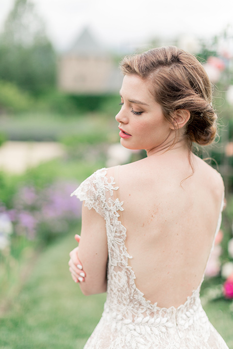 bride in a champagne gown with a low cut back with a lace trim detail