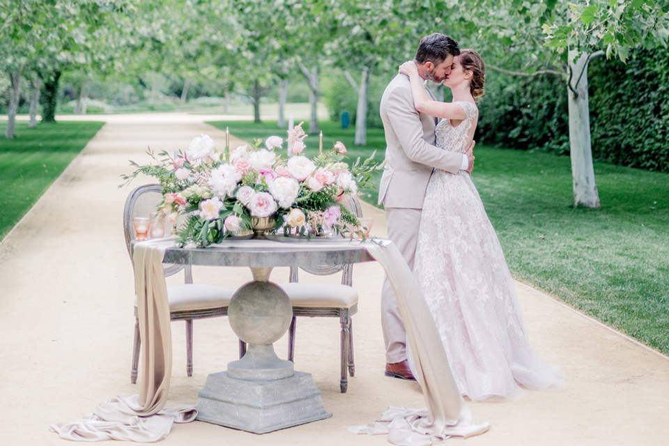 Bride and groom standing by their sweetheart table