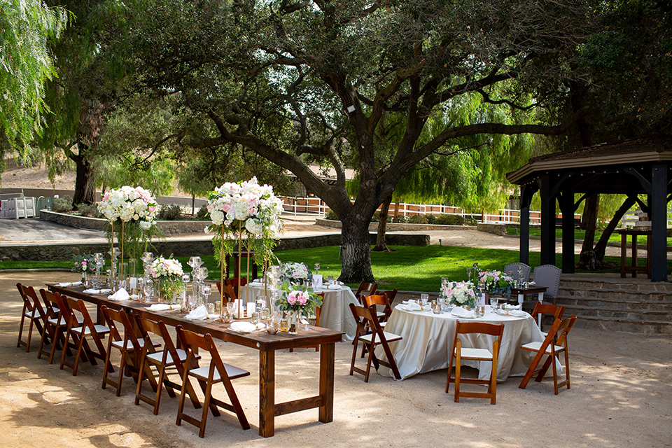 wooden tables and chairs with simple décor and white floral arrangements