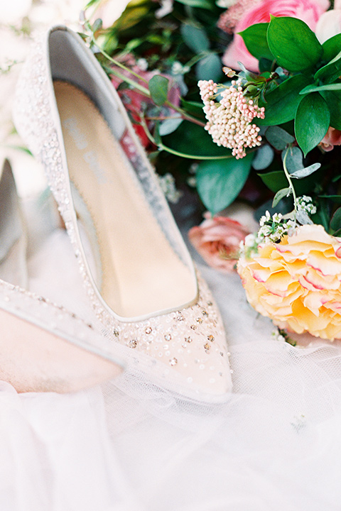 white bridal shoes with lace detailing and florals