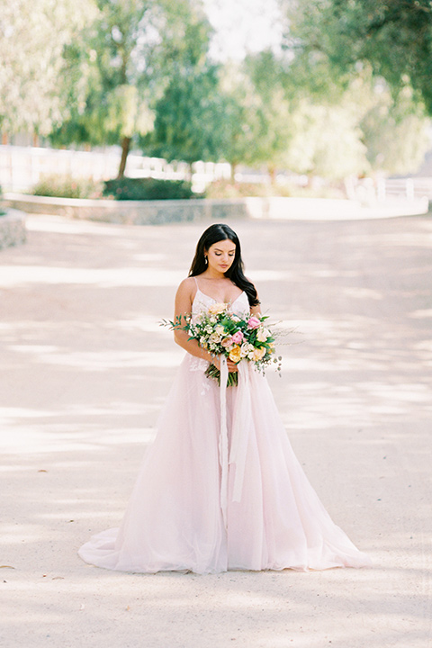 bride in a blush bridal gown with thin straps and a sweetheart neckline