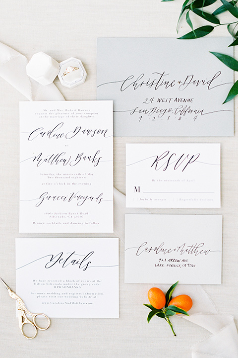 white invitations with green lettering