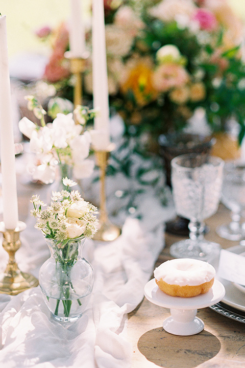  colorful garden flowers and tall candles with colorful crystal and white linens