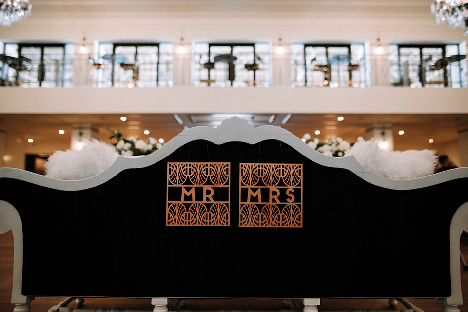 Art deco and roaring twenties inspired mr and mrs signs on the backs of the chairs