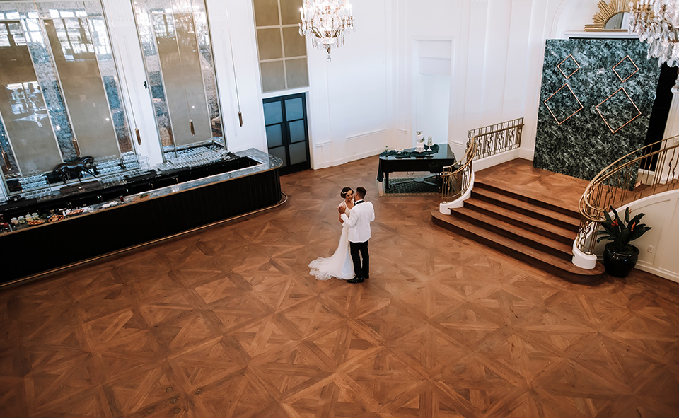 bride and groom dancing in a big hall