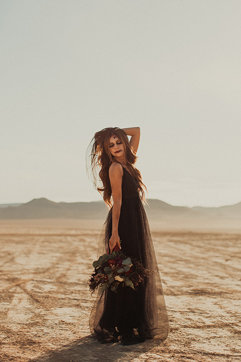 Halloween shoot with the bride in a burgundy and black tulle gown and a black veil