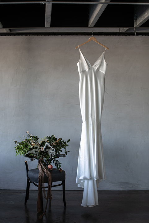  white satin gown hanging at venue