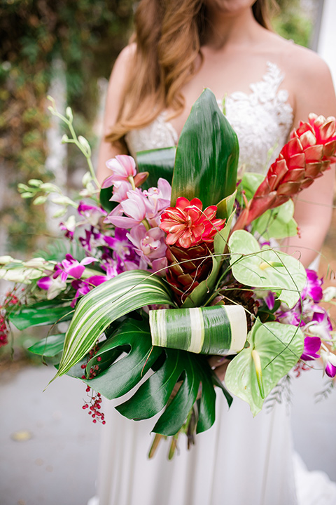 bride holding a tropical floral bouquet
