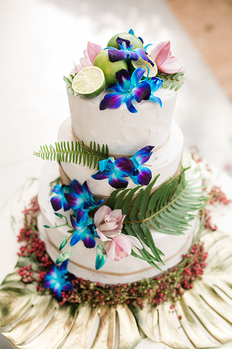  white tiered cake with tropical flowers