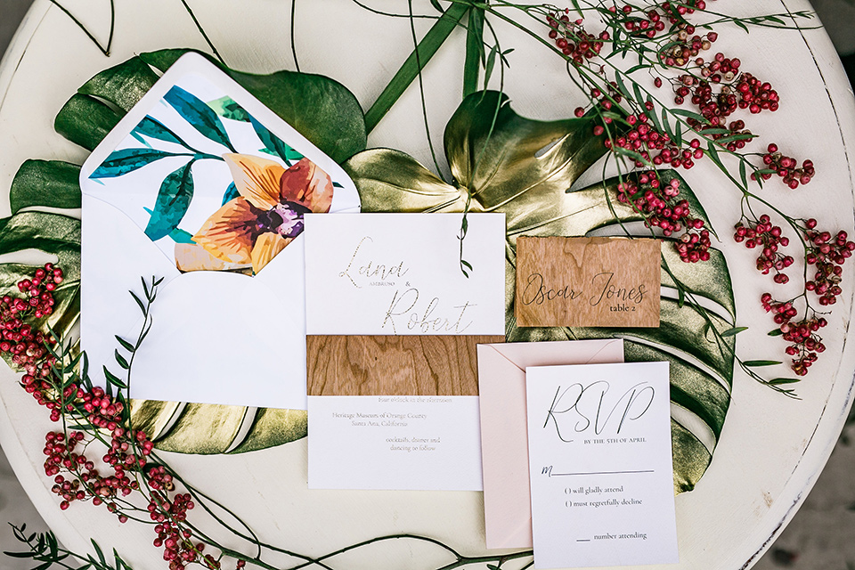 white invitations with tropical detailing