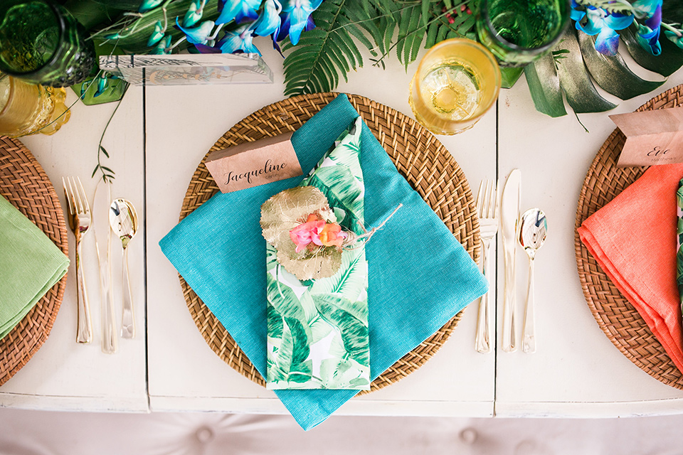 wooden table with bright colored napkins and flowers 